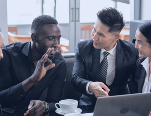 Diverse team meeting to discuss ensuring compliance with local laws and regulations for global payroll. They're evaluating a solution for global payroll compliance, including outsourcing and processing services.