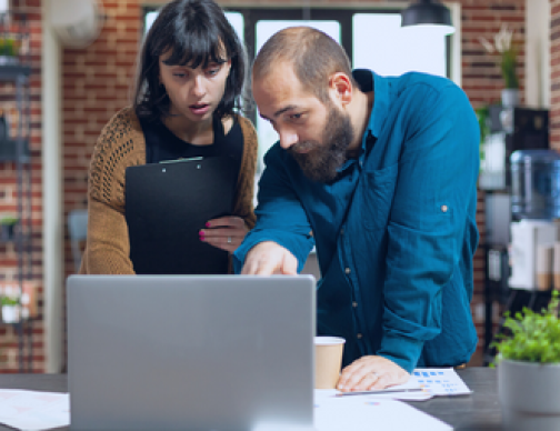 A business meeting focused on a streamlined solution for managing global payroll across multiple countries. The image depicts professionals discussing a single platform that simplifies compliance, processing, and overall payroll services.