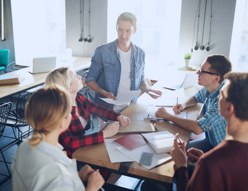 A meeting of micro-multinational company representatives discussing Neeyamo's Global Work Solution. The group is evaluating solutions for global payroll, including compliance, processing, and services specifically designed for micro-multinationals.
