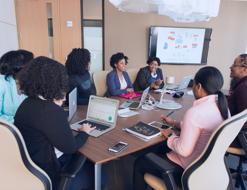 A meeting of business professionals focused on navigating the complexities of HR and payroll regulations on a global scale. The discussion centers on ensuring compliance with international requirements.