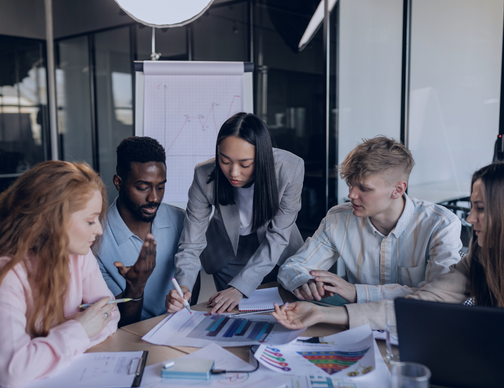 A business meeting focused on deploying Neeyamo's Global Payroll solution. The group is discussing how to streamline payroll processes for their international operations using a single, unified platform.