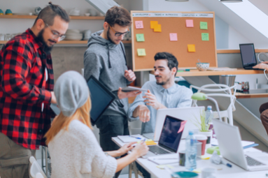 A diverse group of professionals discussing solutions to support the rapid global expansion of small and medium-sized businesses (micro-multinationals). Topics include global payroll challenges, compliance, processing, and outsourcing options.