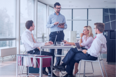 Diverse team strategizes with global payroll solutions for multinational growth