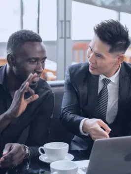 Two professionals in office setting engaged in a focused and serious business discussion over global payroll & Employer of record strategies 